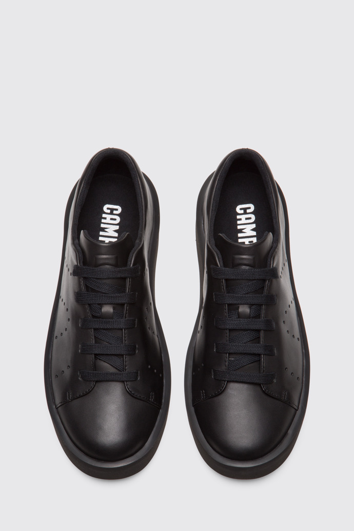 Overhead view of Courb Men's minimal, soft black sneaker