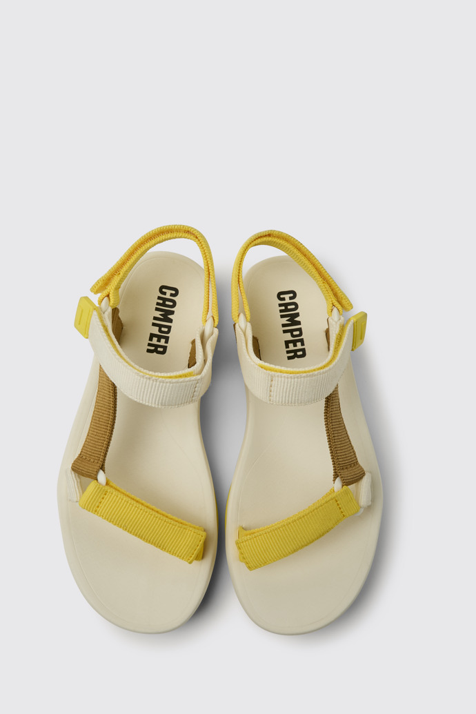 Overhead view of Match Yellow, white, and brown sandals for women