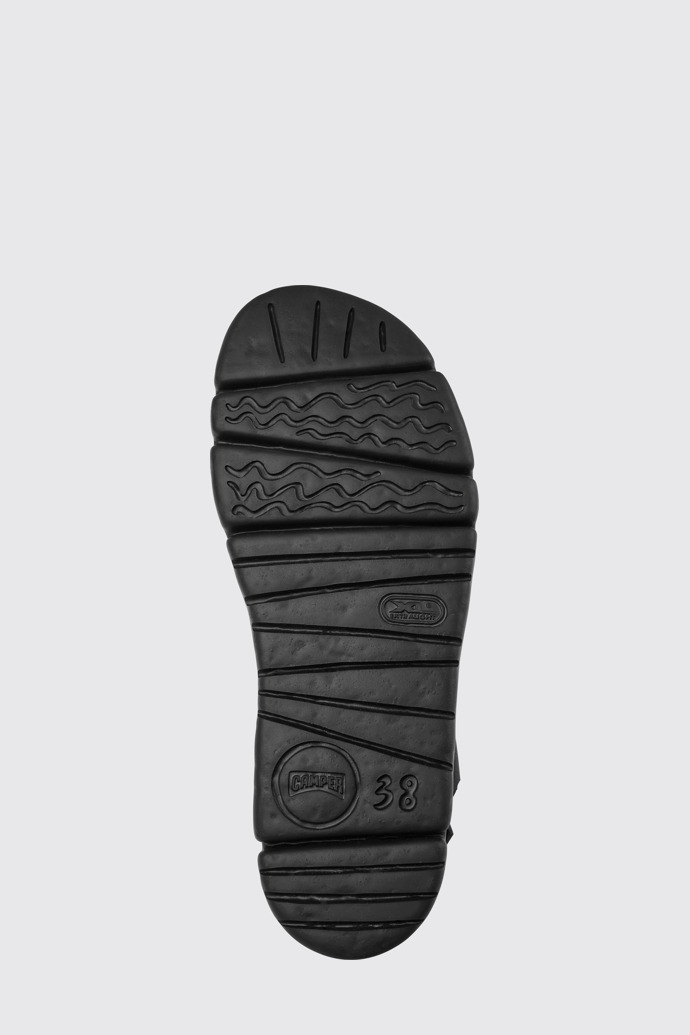 The sole of Oruga Up Black, brown, and green leather sandals for women