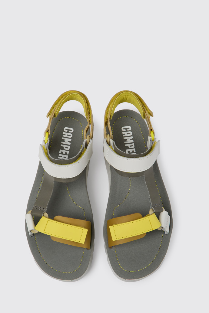 Overhead view of Oruga Up White, grey, and yellow leather sandals for women