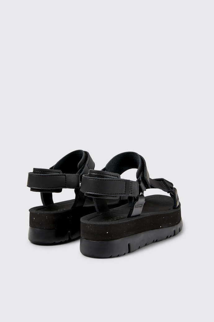 Back view of Oruga Up Black leather sandals for women