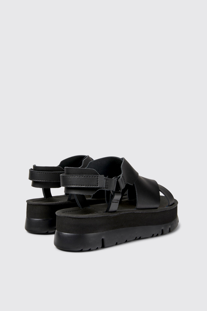 Back view of Oruga Up Black leather sandals for women