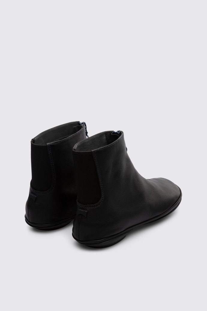 Back view of Right Black zip up ankle boot for women