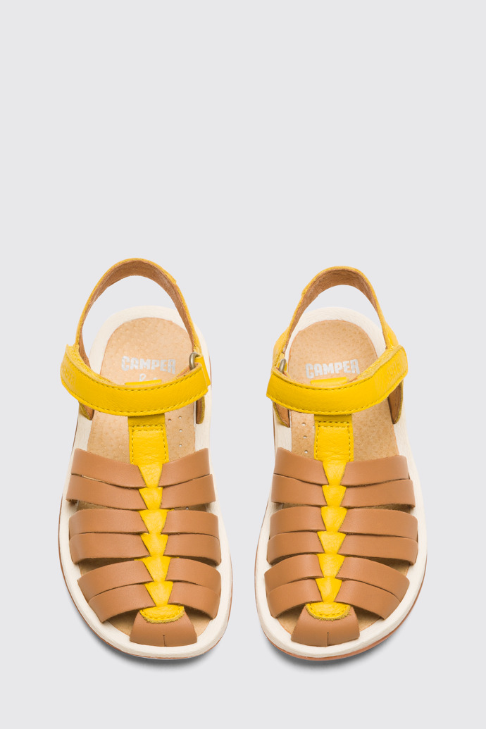 Overhead view of Bicho Closed yellow and tan nude T-strap sandal for kids