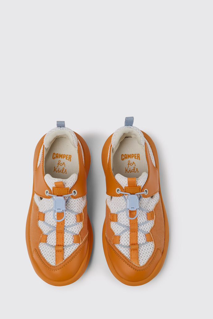 Overhead view of CRCLR White and orange sneakers for kids