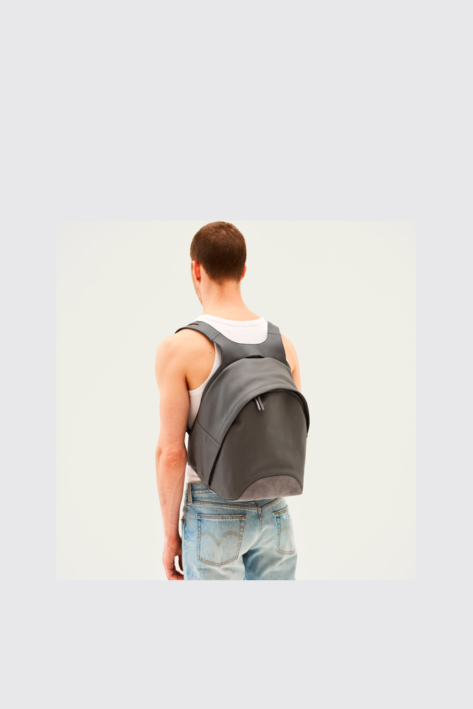 A model wearing Naveen Grey Backpacks for Unisex