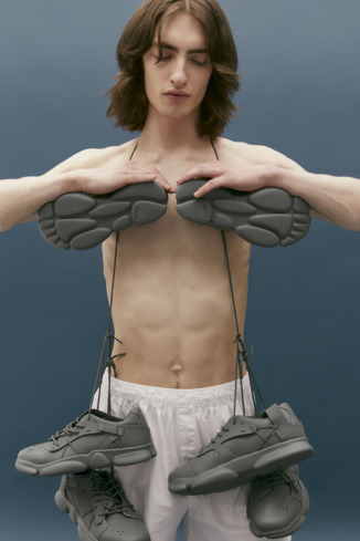 A model wearing Karst Gray leather and textile sneakers for men