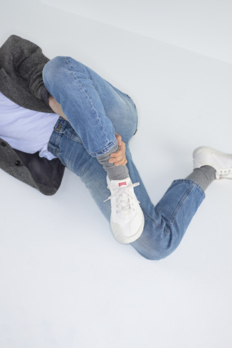 A model wearing Path White textile sneakers for men