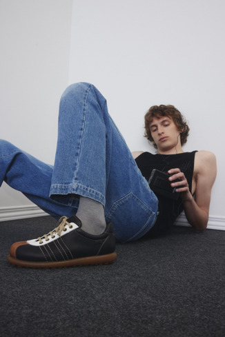 A model wearing Pelotas Multicolor Leather Shoes for Men.