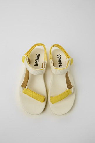 Overhead view of Match Yellow, white, and brown sandals for women