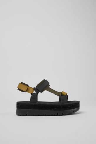 Side view of Oruga Up Black, brown, and green leather sandals for women
