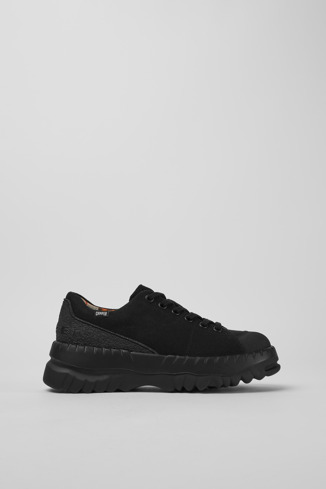 Side view of Teix Black rubber and BCI cotton shoes