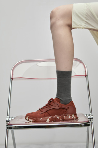 A model wearing Karst Red nubuck and textile sneakers for women