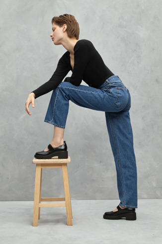 A model wearing Milah Black Leather Women's Shoe.