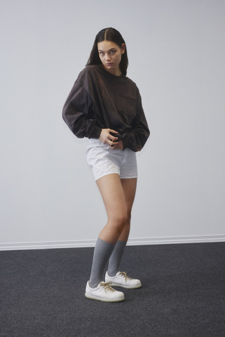 A model wearing Pelotas White Leather Shoe for Women.