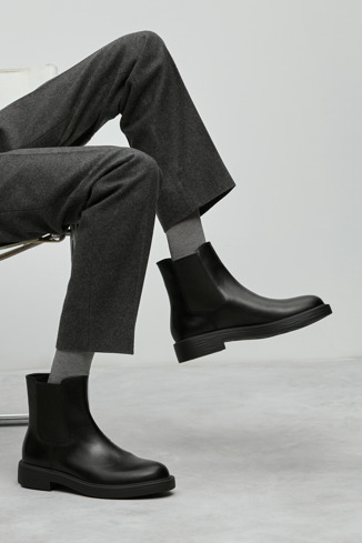 A model wearing Dean Black leather ankle boots for men