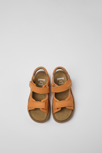 Overhead view of Bicho Orange leather sandals for kids