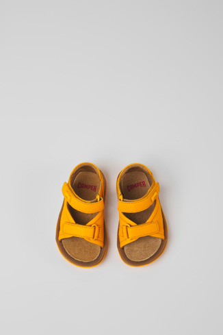 Overhead view of Bicho Yellow leather sandals for kids