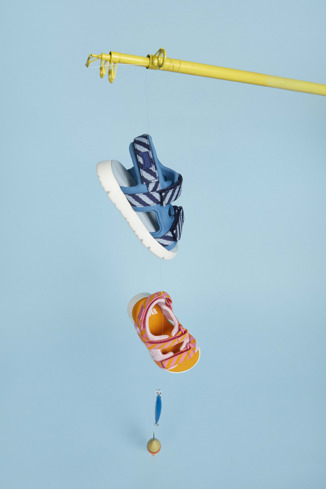 A model wearing Oruga Blue textile sandals for kids
