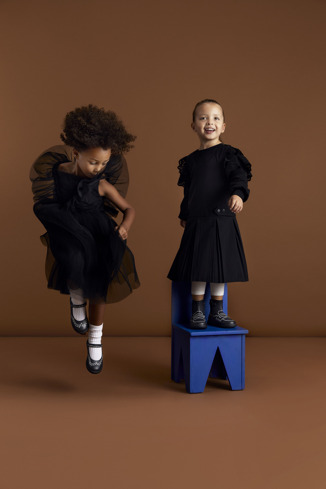 A model wearing Twins Black leather Mary Jane shoes for kids