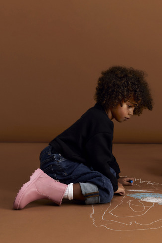 A model wearing Norte Pink leather ankle boots for kids