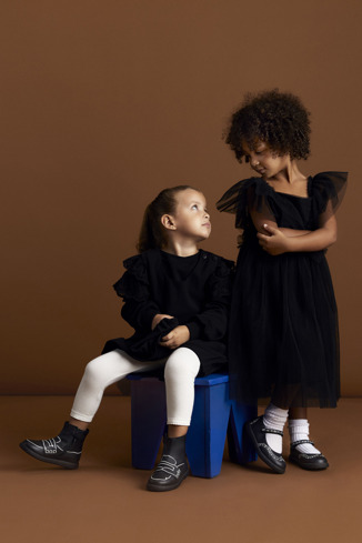 A model wearing Twins Black leather ankle boots for kids