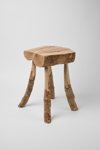 Side view of 'Ullastre' stool Handmade olive wood stool