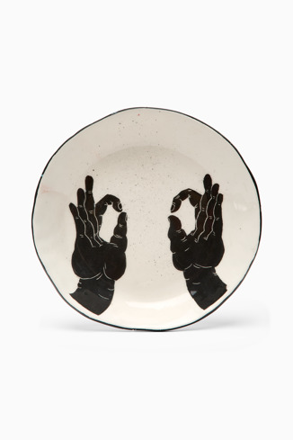 Side view of Ceramic plate with hands White and black handmade plate